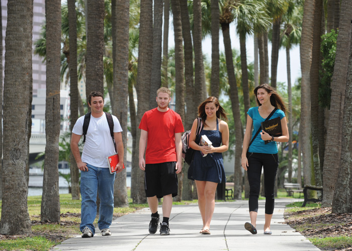 Four students walking in Plant Park